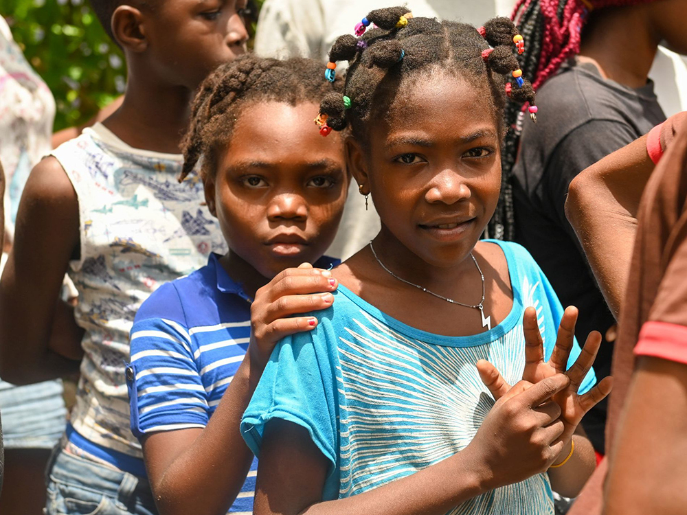 Two children from Haiti observe as the Coast Guard performs a medevac on Aug. 24, 2021 following the 7.2 magnitude earthquake in Haiti. (Credit: U.S. Coast Guard photo by Petty Officer 3rd Class Kimberly Reaves; CC BY-NC-ND 2.0)