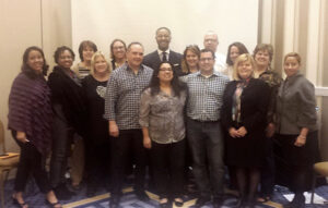 PEAK Grants Management Directors Circle in an indoor group photo against a white wall 