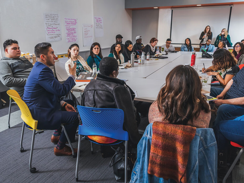 Members of Liberty Hill Foundation sit around a table with community partners.