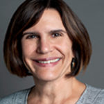 Jennifer Pedroni is smiling in her headshot and is wearing a grey round neck top