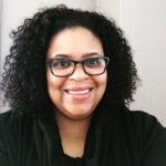 Traci smiles in her headshot.