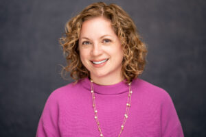 Lita smiles in her headshot.