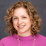 Lita smiles in her headshot.