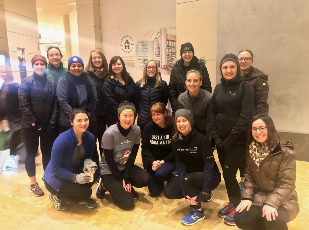 A group shot of Denver conference attendees, dressed to take on the outdoors in the form of running, walking, and moving.