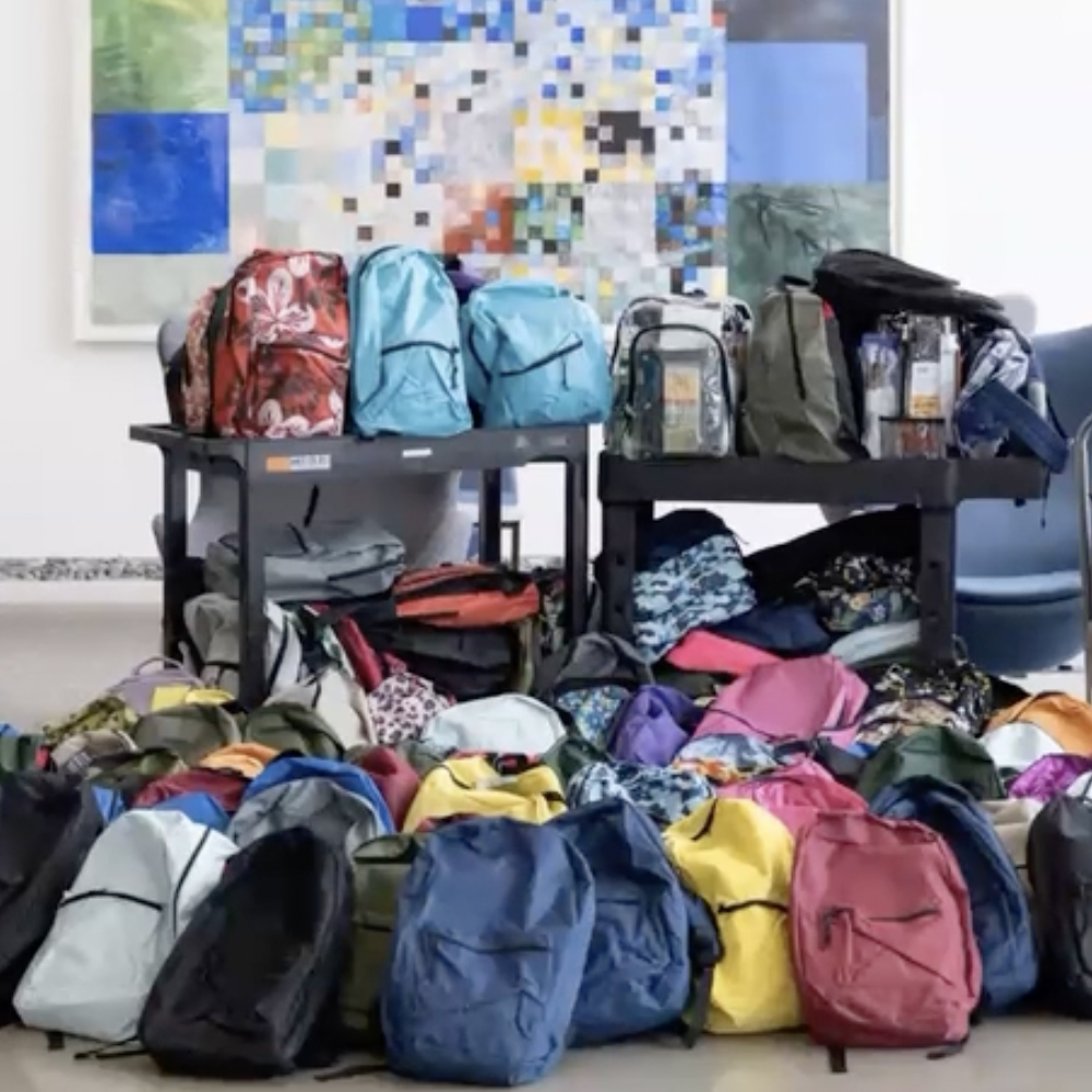 A preview of the presentation, which shows backpacks from a volunteer event.